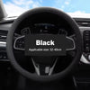 Black universal silicone steering wheel cover shown in a car interior context.