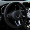 A black PU carbon fiber steering wheel cover is shown in a car interior.