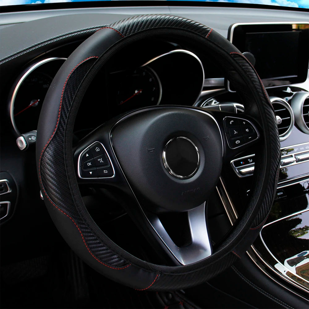 A black PU carbon fiber steering wheel cover is shown in a car interior.