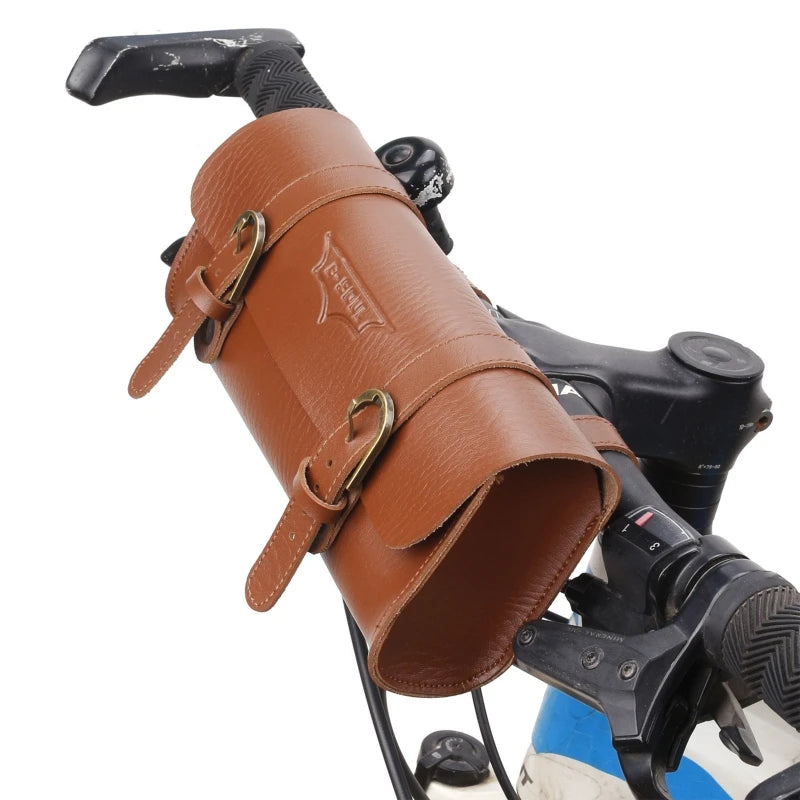 A brown PU leather motorcycle handlebar saddlebag with a black grip and leather straps.
