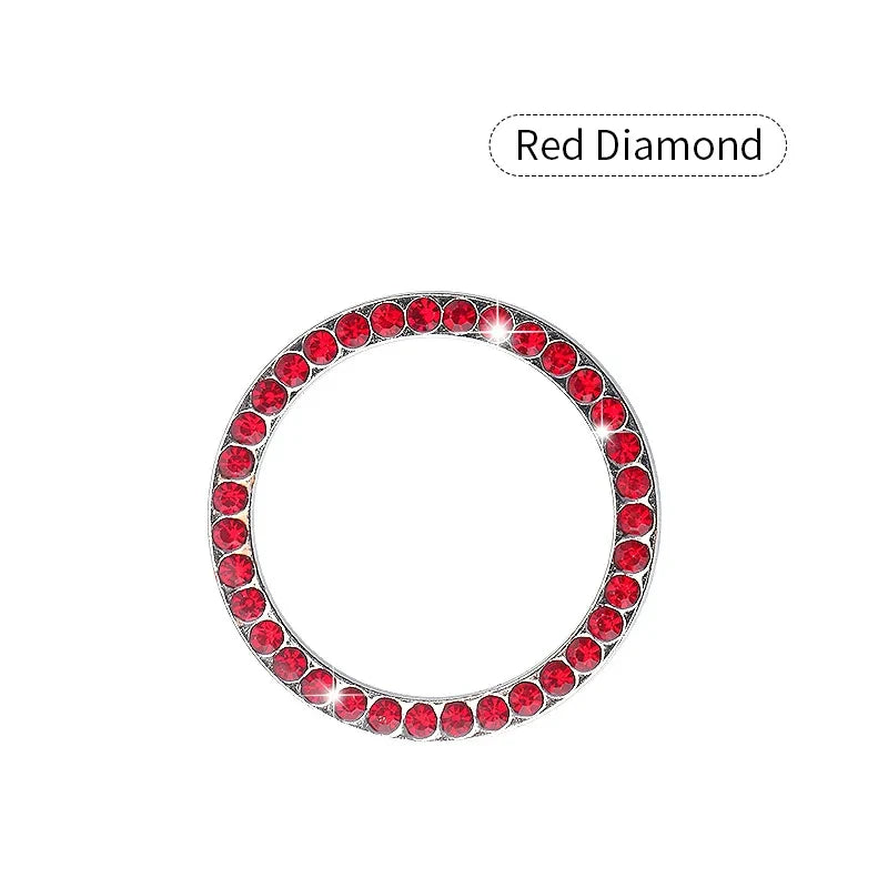 A circular red diamond decorative ignition push button cover for a car.