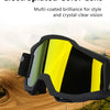 A pair of electroplated color lens goggles with a yellow tint resting on a dirt road.