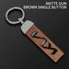 Brown matte gun single button key case with silver keyring and metal attachment.