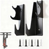 A pair of black heavy-duty metal floor jack stands and several assorted metal and plastic spikes are displayed against a whit