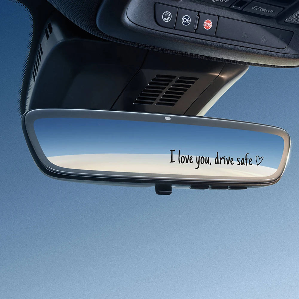 A car rearview mirror with a message that reads I love you drive safe