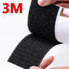 Black hook and loop tape strips being held by a hand, showing the texture and thickness of the material.