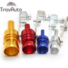 A collection of various metal turbo sound exhaust whistles and fittings in gold, red, blue, and silver.