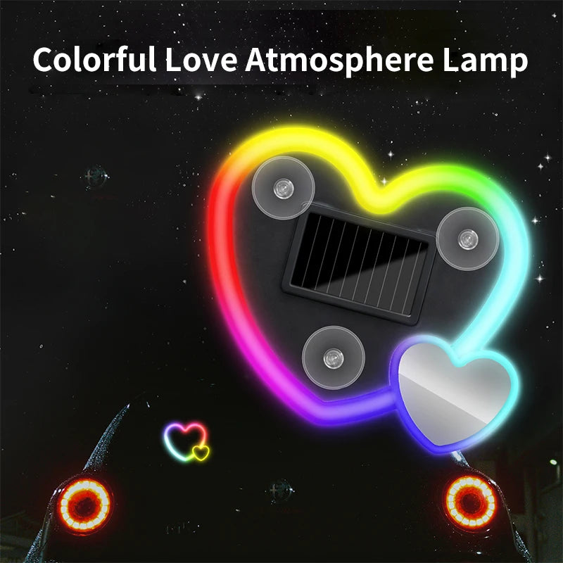 A colorful heart-shaped love atmosphere lamp with glowing lights and a solar panel visible against a dark background.