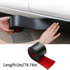 A hand is applying a black self-adhesive PVC car side protection strip to a white car door.