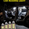 Un jeu d'ampoules feston LED Canbus exposées sur une surface texturée, avec l'intérieur d'une voiture visible en arrière-plan