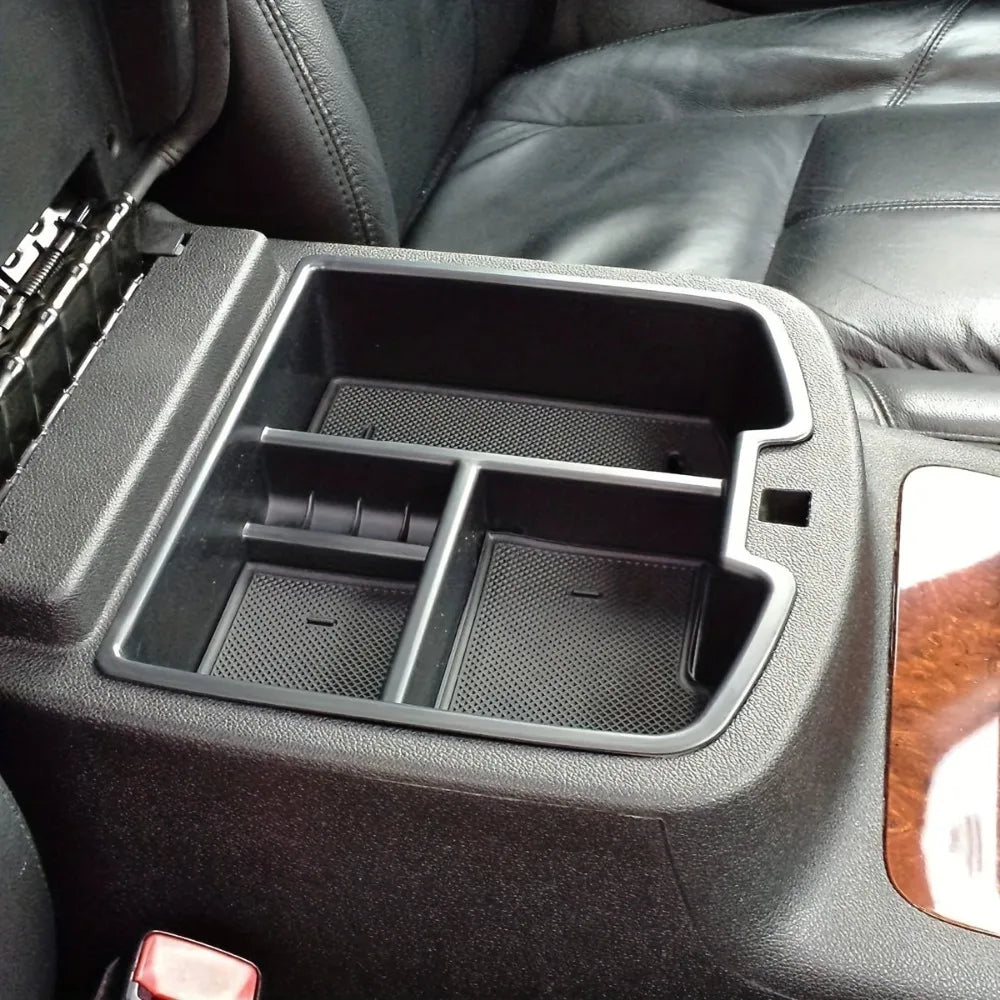 A black convertible armrest storage tray is shown in a vehicle interior.