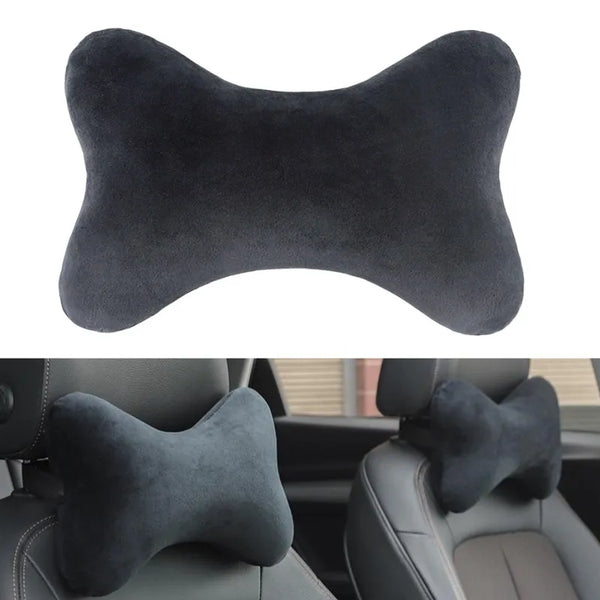 A black memory foam car neck pillow placed on a car seat cushion.