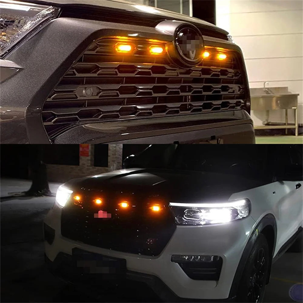 Primer plano de la parrilla oscura de una camioneta con luces marcadoras LED iluminadas.