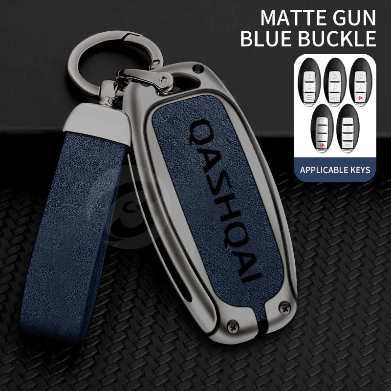 A matte gun blue buckle key cover with a silver metal loop and strap, shown on a black textured surface.