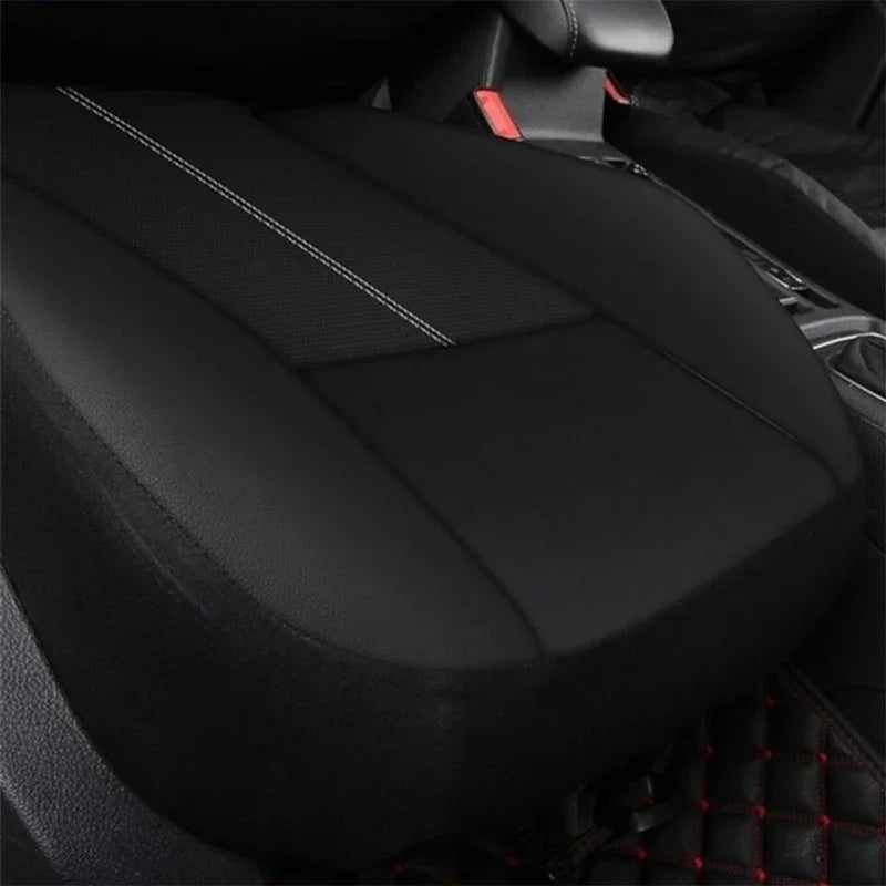 Black universal PU leather car seat cover set shown in a close-up view inside a vehicle.