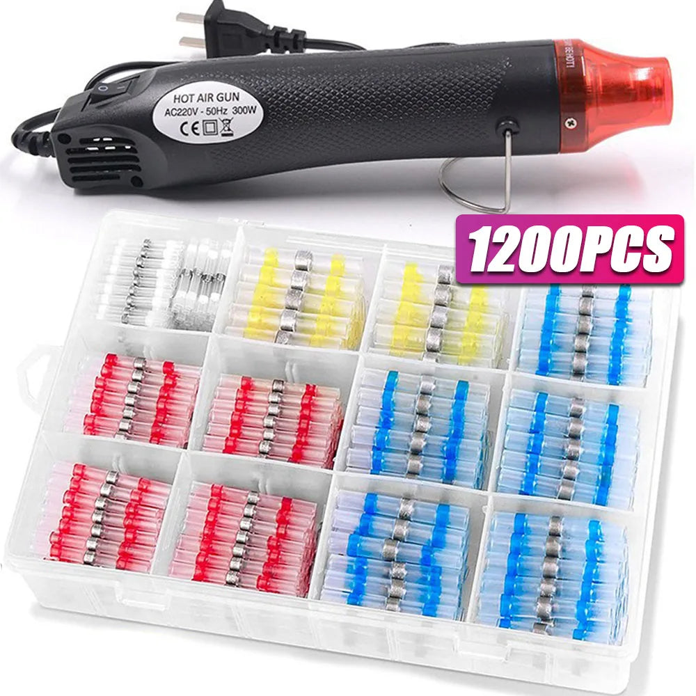 A black hot air gun with a wire clamp and a plastic box containing 1200 pieces of heat shrink wire terminals in various color
