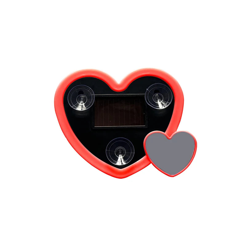 A decorative heart-shaped solar lamp with a dark panel and surrounding red casing.