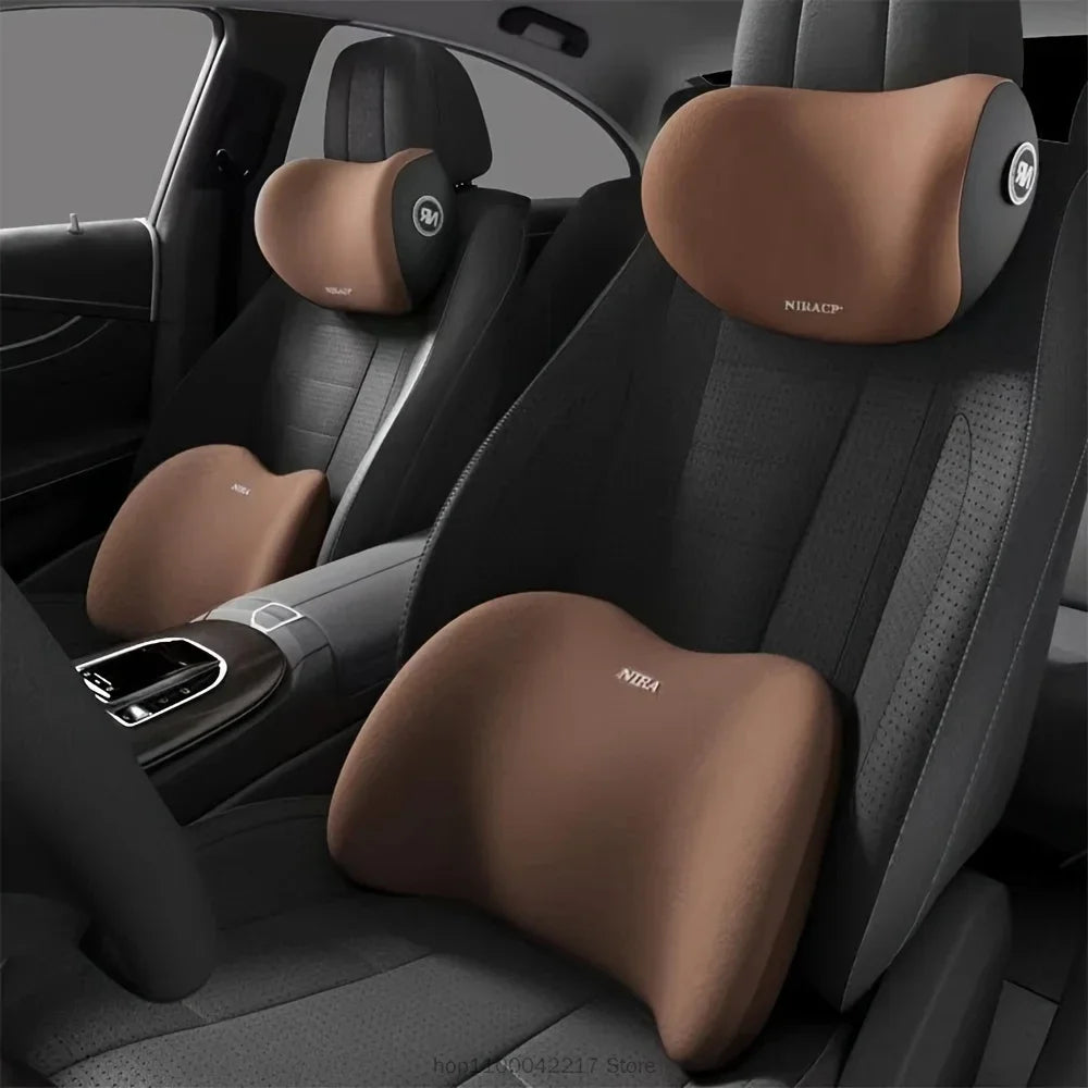 Interior view of a car seat showing a brown neck support pillow installed on the headrest.