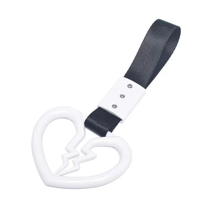 Black strap with a white heart charm and a white loop for a JDM Tsurikawa product