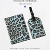 A black and teal leopard print passport holder featuring card slots.