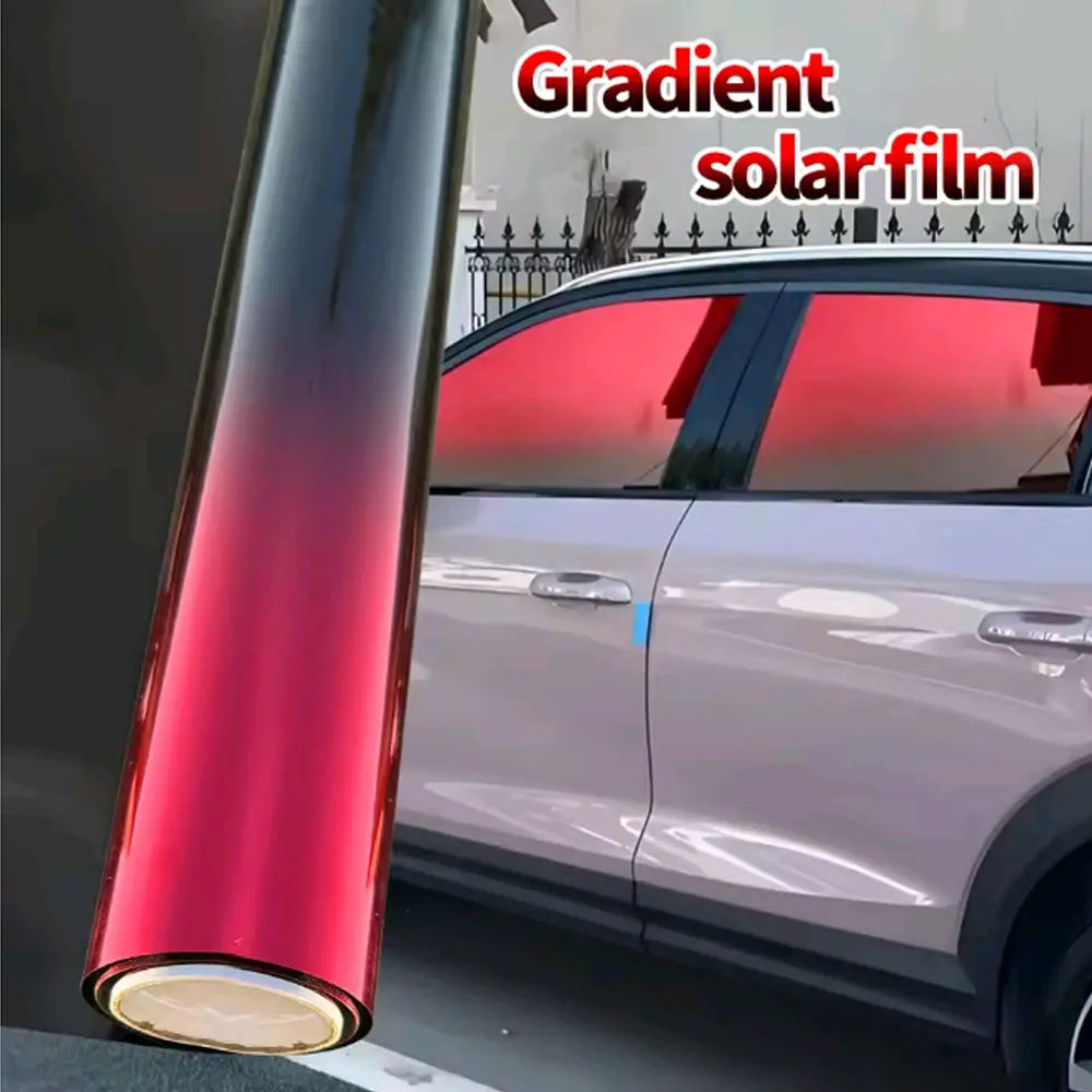Close-up of a red gradient solar film being applied to a car window.