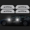 Four reflective decals showing open door warnings applied to a dark car door.