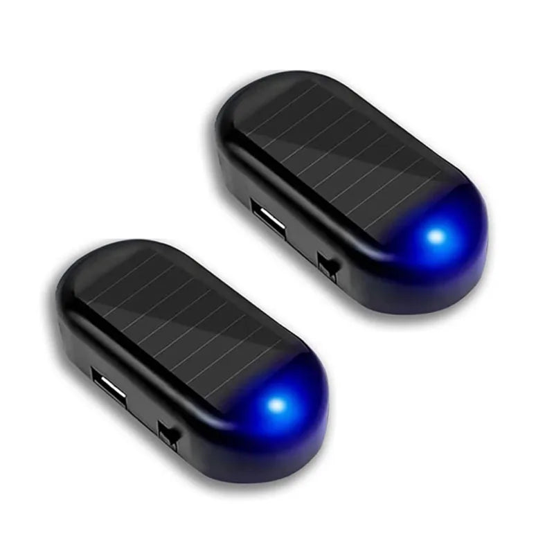 A black solar powered anti-theft car warning light with a blue illuminated tip.