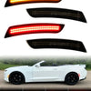 A set of aftermarket LED turn signal lights for a white sports car, shown in various colors and mounted on the vehicle.
