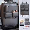 A black luxury car seat back organizer bag filled with various accessories like bottles and small items.