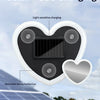 A heart-shaped solar charger with a panel and detachable suction cups is shown against a background of solar panels.