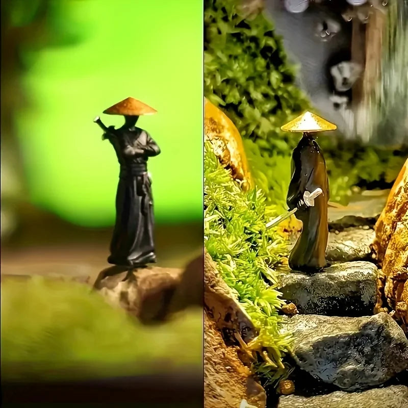 A pair of miniature samurai statues with conical hats are displayed in a natural, mossy outdoor setting.