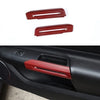 Close-up view of a red carbon fiber car interior door handle trim piece.