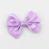 A lilac silk hair bow tied in a neat bow shape.