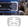 Close-up of a blue Ford F-250 or F-350 grille and headlight assembly with an invisible paint protection film applied.