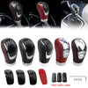 A set of black and red manual gear shift knobs with interchangeable speed covers and various sizes.