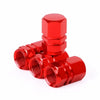 A set of shiny red aluminum alloy tire valve caps for auto and motorcycle tires.