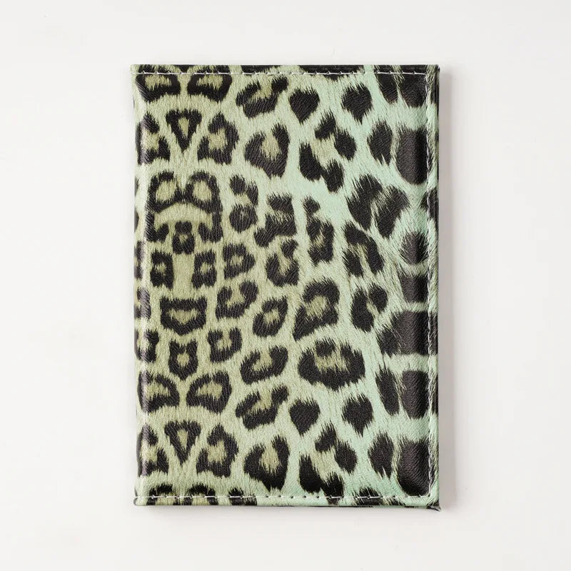 A black and beige leopard print passport holder with card slots.