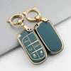 A gold-toned TPU car key case cover with a green finish and a keyring is shown against a white background.