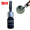 A black bottle of windscreen repair resin with a silver applicator tip shown next to a cracked glass surface.