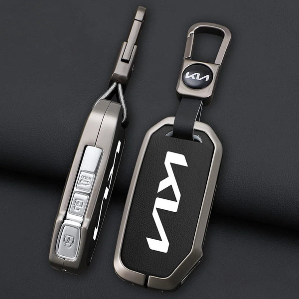 A close-up view of a silver and black universal car key case cover with a metal keyring.