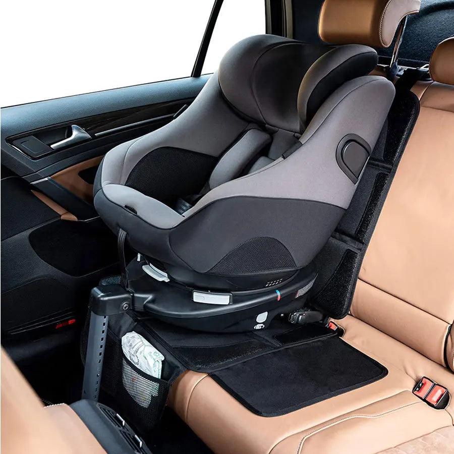 A car seat protector pad installed in a vehicle seat, showing the protective cover and mounting mechanism.