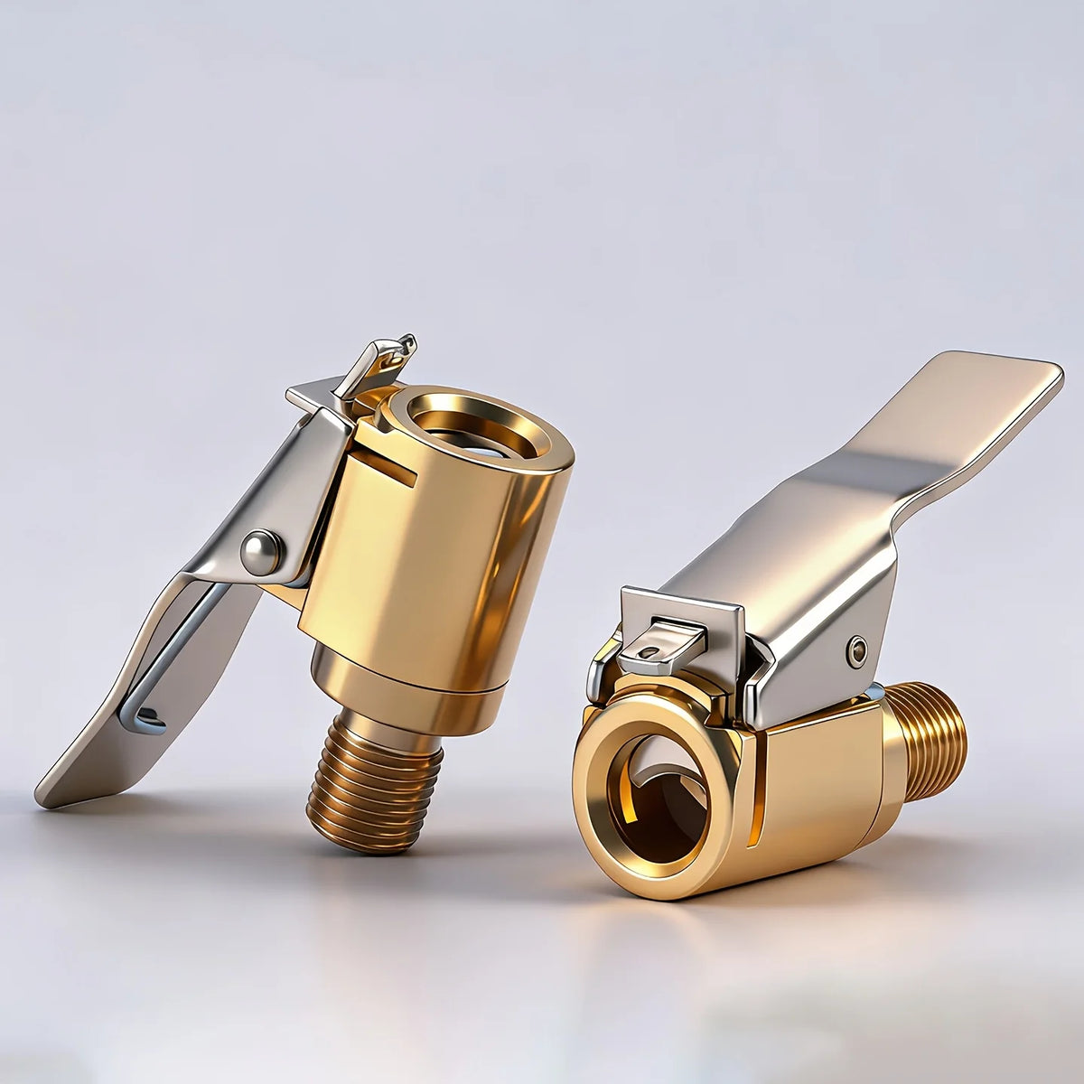 A pair of solid brass tire inflator valve connectors shown in a close-up view.