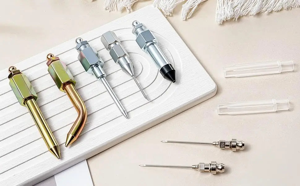 A white tray displays a 7-piece grease gun needle and fitting kit with various metal tips and fittings.