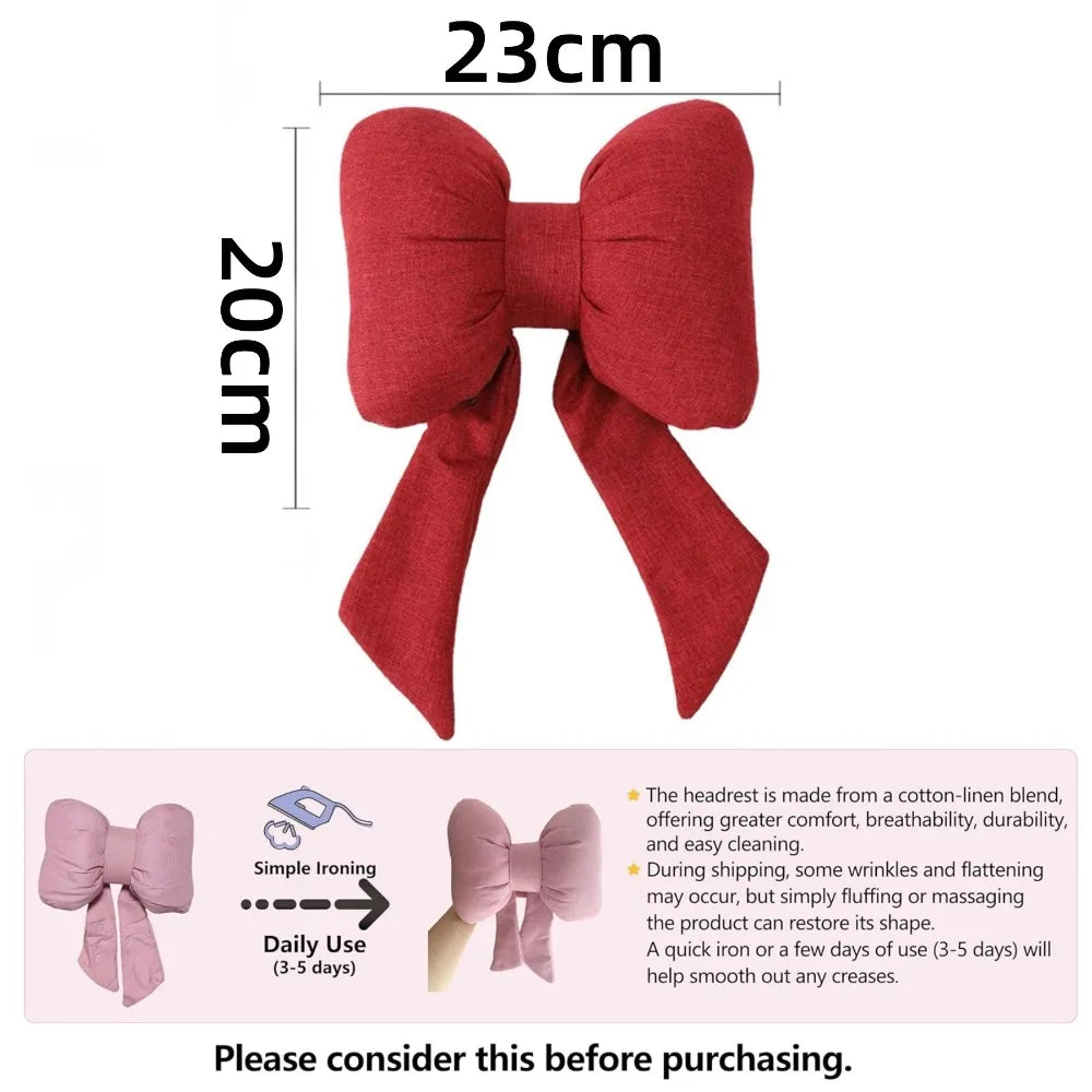 A red bow knot car neck pillow with a large fabric bow shown against a white background.