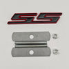 A silver metal emblem badge with a black and red SS graphic and mounting holes.