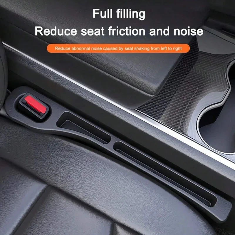 A black car seat gap filler organizer with a textured surface and a red accent is shown in a vehicle interior.