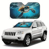 A foldable car windshield sun shade is shown installed on a white SUV, with an image of a sea turtle visible through the shad