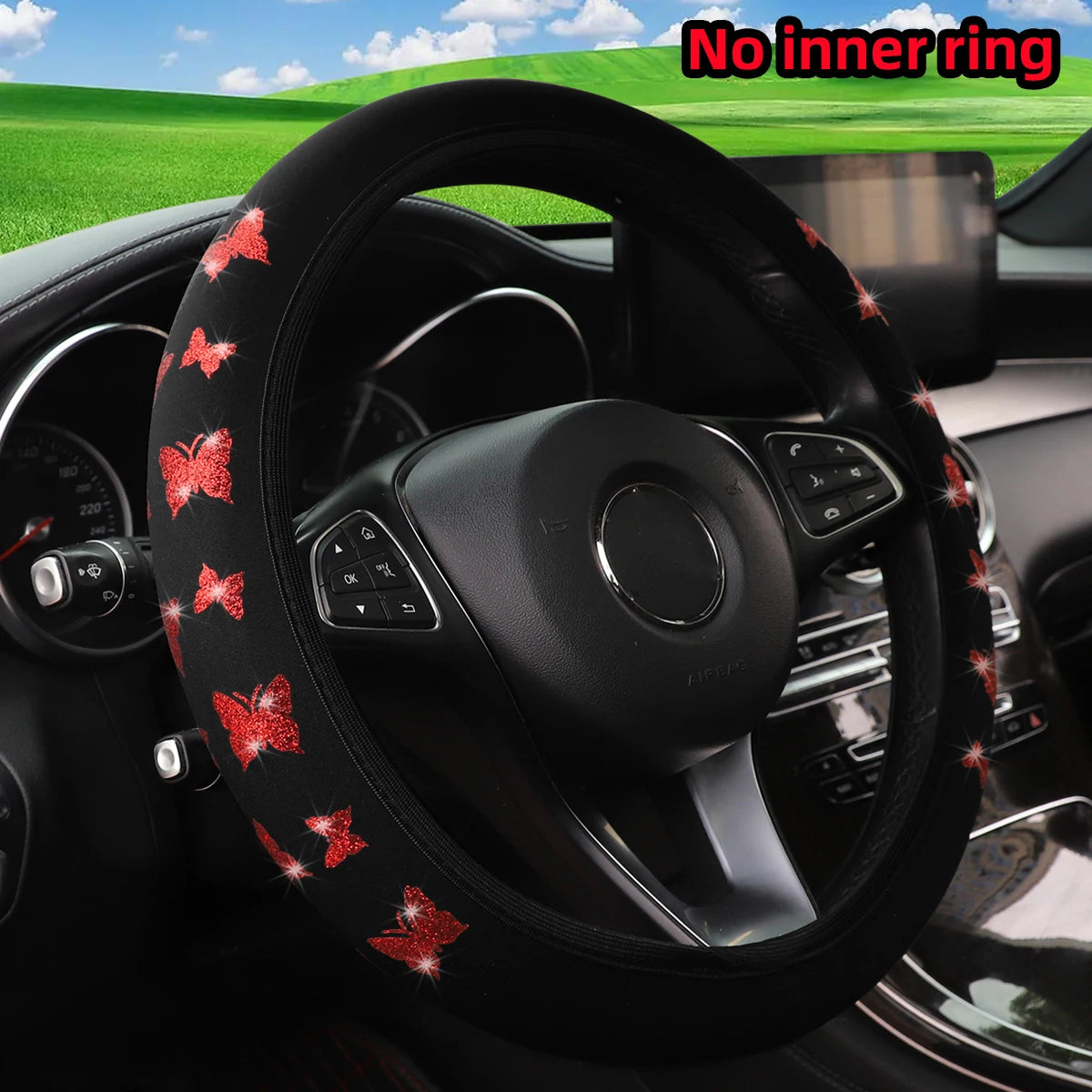 Black steering wheel cover decorated with red glitter butterflies in a car interior setting.