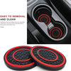 A set of two black and red silicone coasters designed for car cup holders.