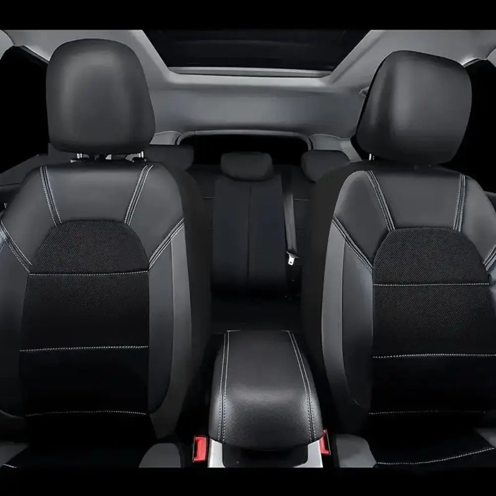 Interior view of a car with black PU leather seat covers installed on the front seats.